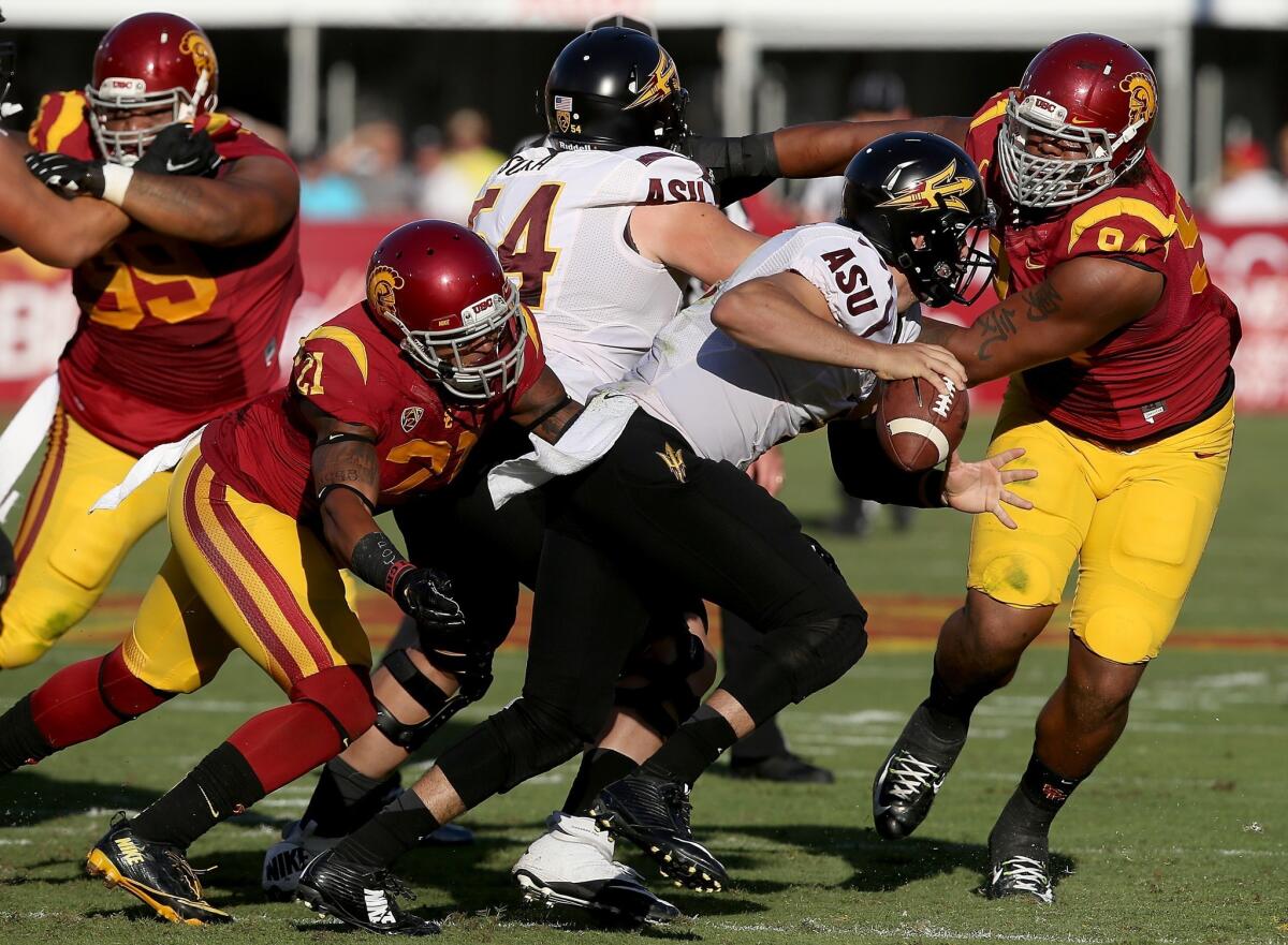 USC safety Su'a Cravens (21) and defensive end Leonard Williams get to Arizona State quarterback Mike Bercovici for a sack in last week's game.