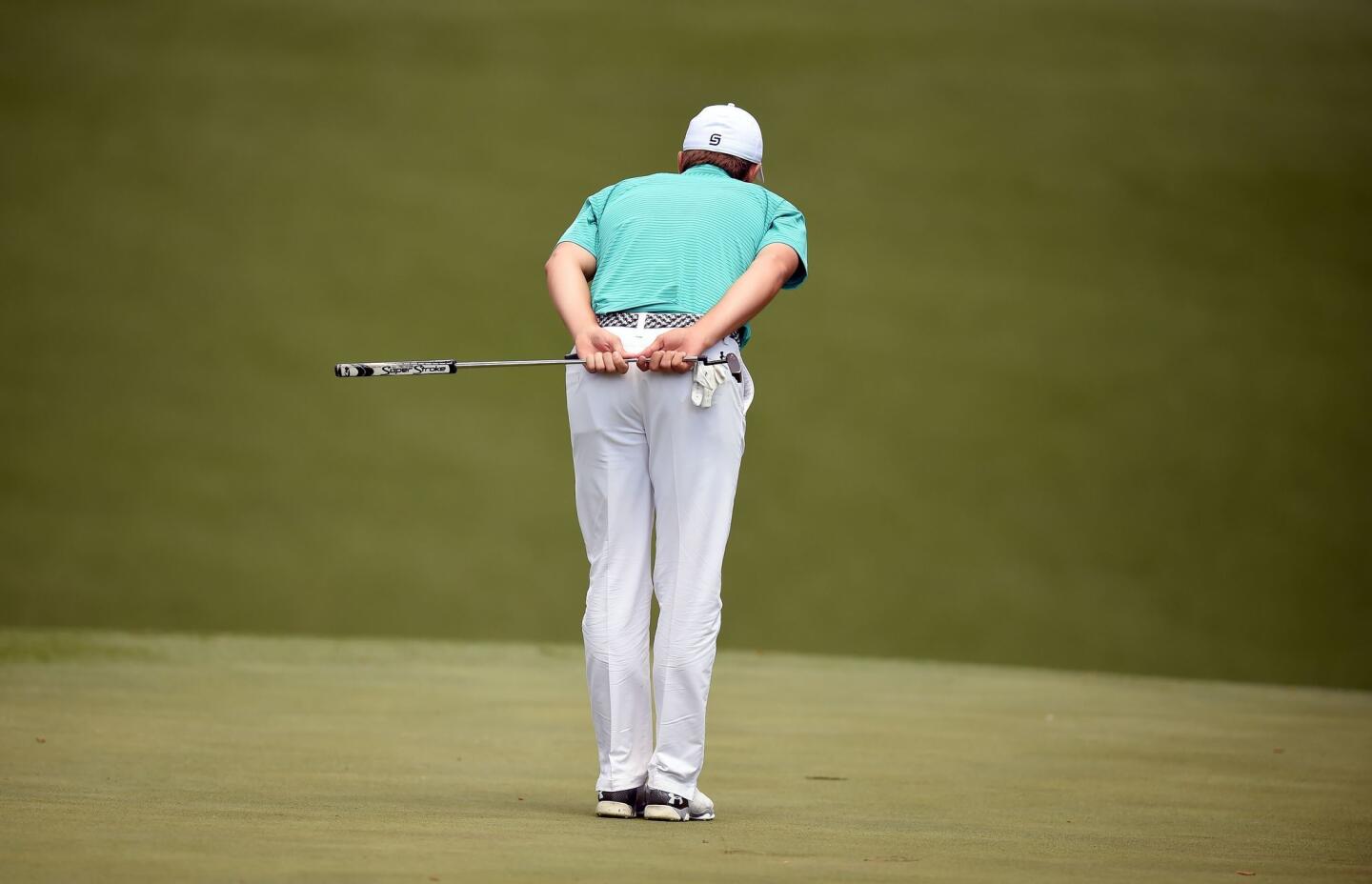 Jordan Spieth lines up a shot during Round 1 of the 80th Masters Golf Tournament at the Augusta National Golf Club.