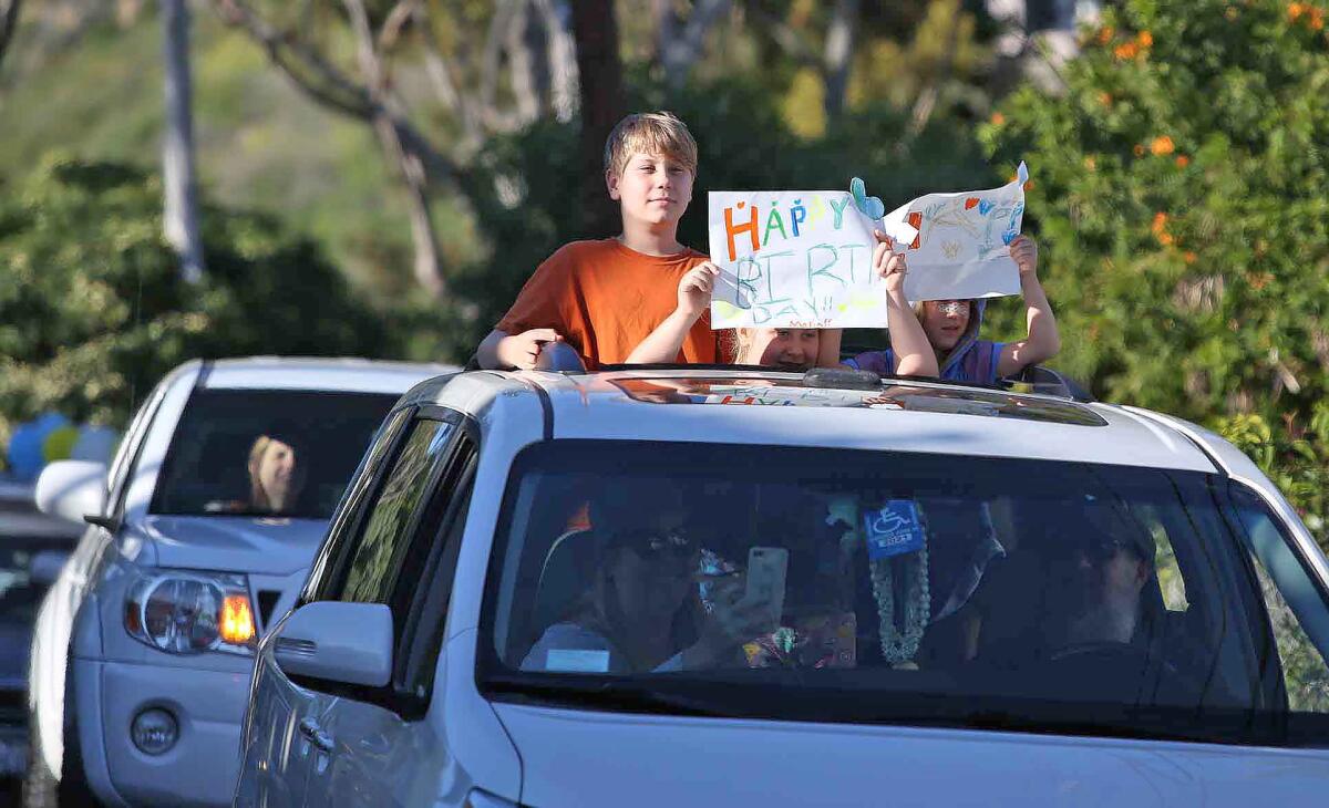 Neighbors celebrate Maria Siani's 96th birthday with a drive-by surprise party in front of her home in Laguna Beach on Wednesday.