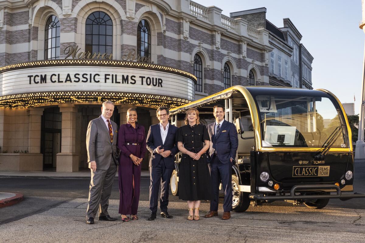 The TCM hosts are seen on on the Warner Bros. backlot.