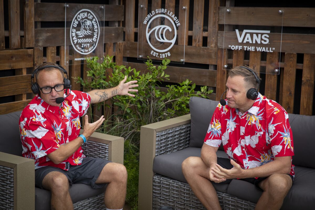 Commentators Chris Cote, left, and Ross Williams work during a live U.S. Open of Surfing broadcast