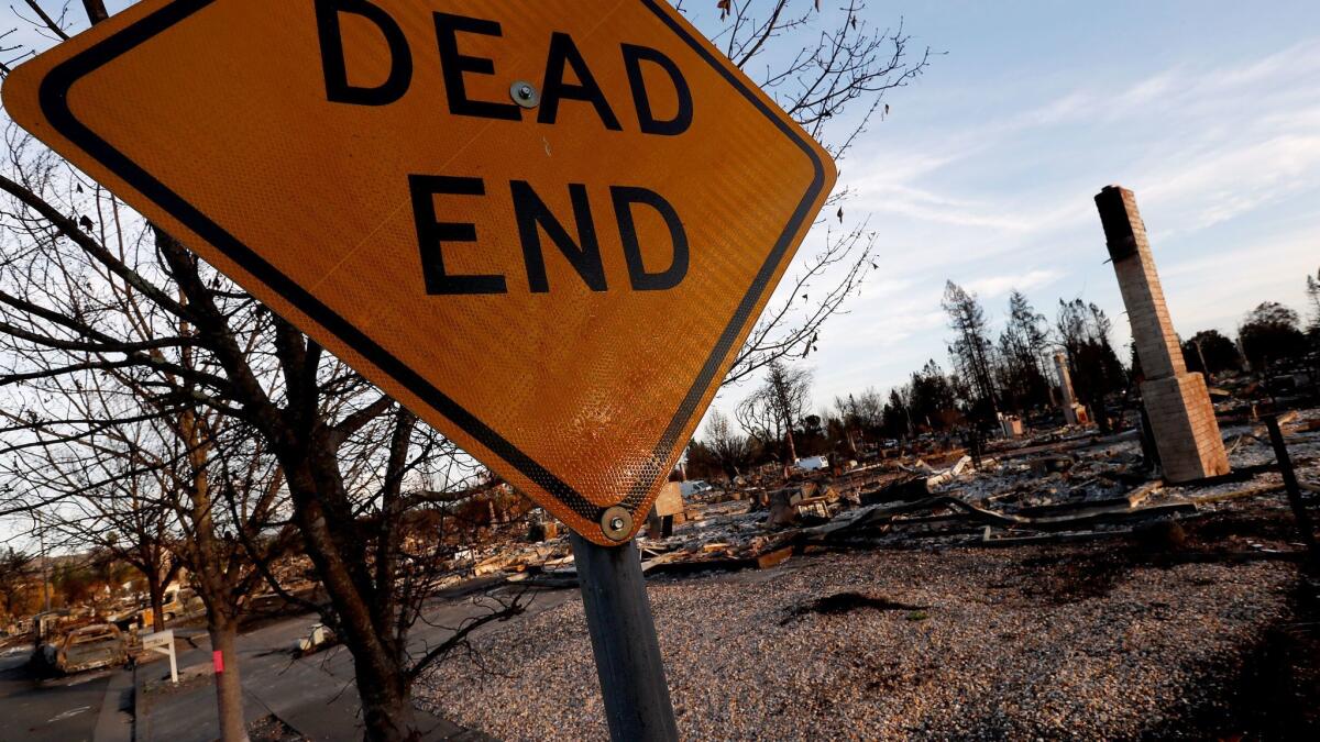 A road sign is virtually all that remains untouched by fire in the Coffey Park neighborhood in Santa Rosa. (Luis Sinco/Los Angeles Times)