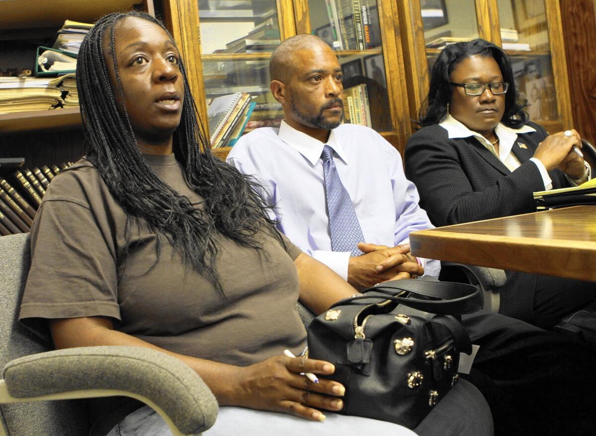 Anya Slaughter, left, and Kenneth McDade, parents of Kendrec McDade, are accompanied by attorney Caree Harper as they speak to the media in 2012 after their son's fatal shooting by Pasadena police.