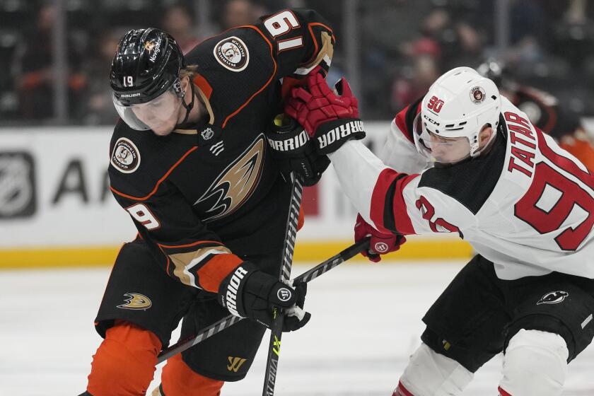 New Jersey Devils left wing Tomas Tatar (90) defends against Anaheim Ducks right wing Troy Terry.