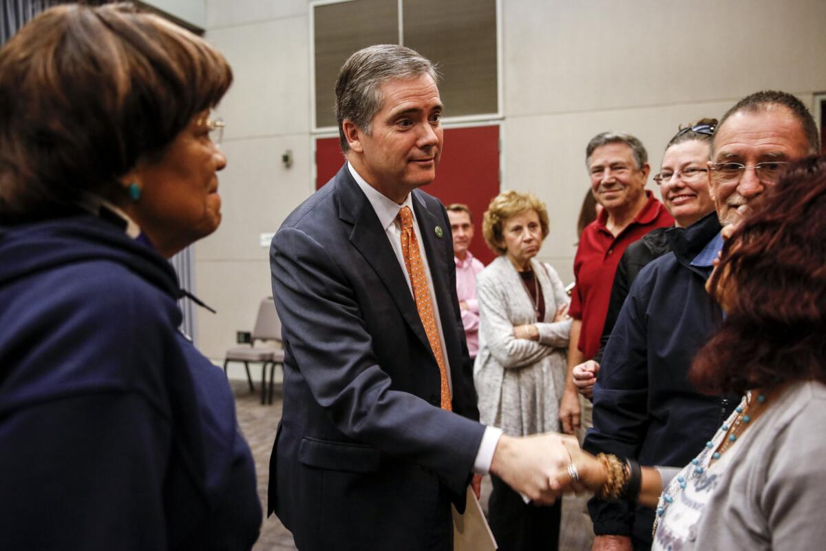Former assemblyman David Hadley, center, greeting voters at a candidate forum in 2016.
