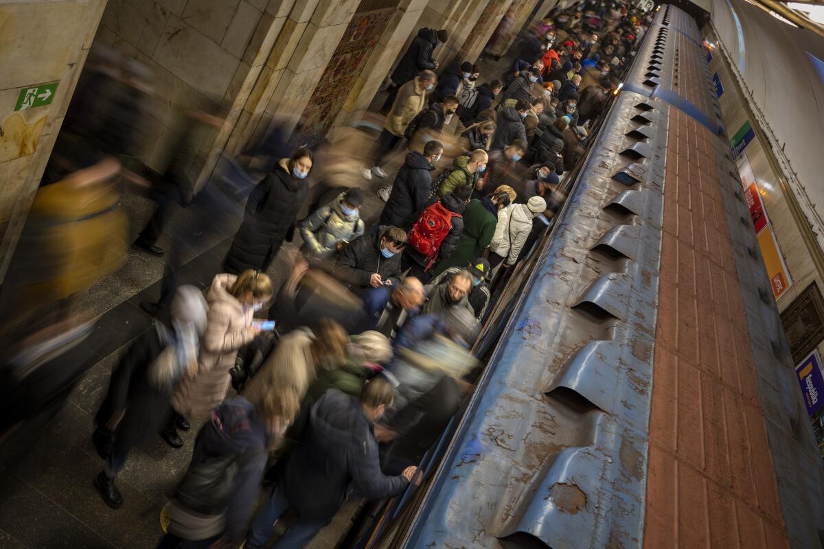 Commuters wait for a local train at a subway station in Kyiv, Ukraine.