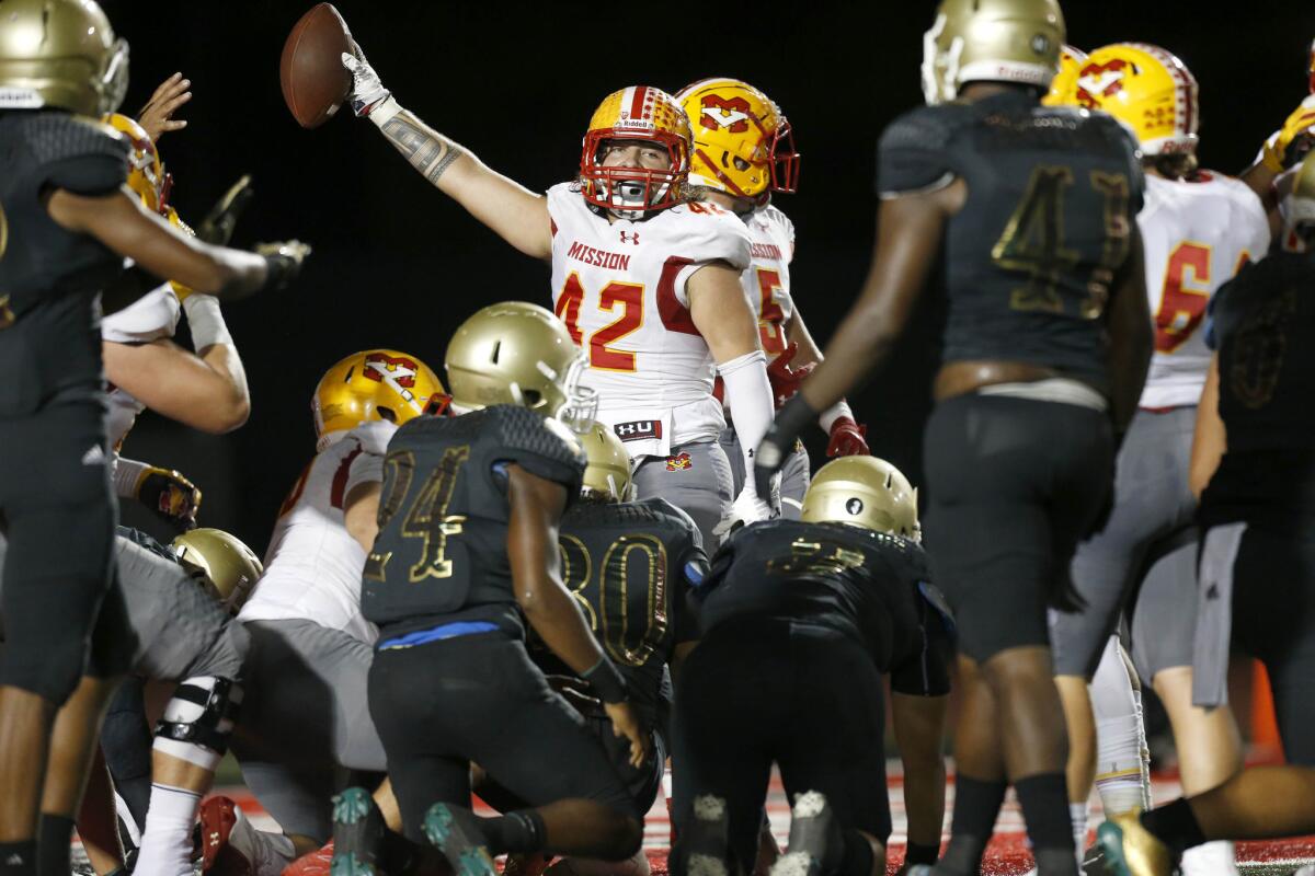 Mission Viejo fullback Shaun Adamson reacts after rushing for a touchdown against the Long Beach during the second quarter Friday night.