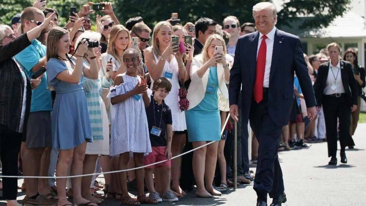 President Trump walks toward reporters before he leaves the White House on Friday.