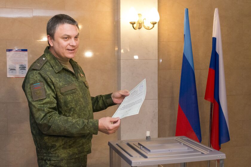 Leonid Pasechnik, leader of self-proclaimed Luhansk People's Republic speaks to journalists as he casts his ballot at a polling station in Luhansk, Luhansk People's Republic controlled by Russia-backed separatists, Ukraine, Tuesday, Sept. 27, 2022. Voting began Friday in four Moscow-held regions of Ukraine on referendums to become part of Russia. (AP Photo)