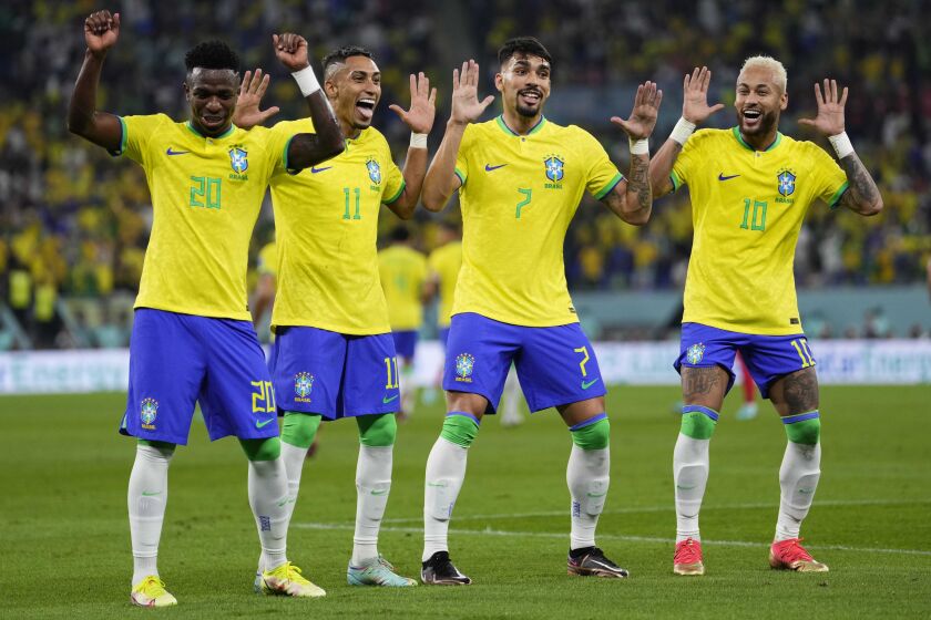 Brazil's Neymar celebrates with teammates Lucas Paqueta, Raphinha and Vinicius Junior after scoring his side's second goal 