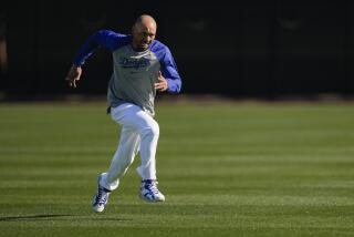 Los Angeles Dodgers' Mookie Betts runs sprints during spring training baseball workouts.