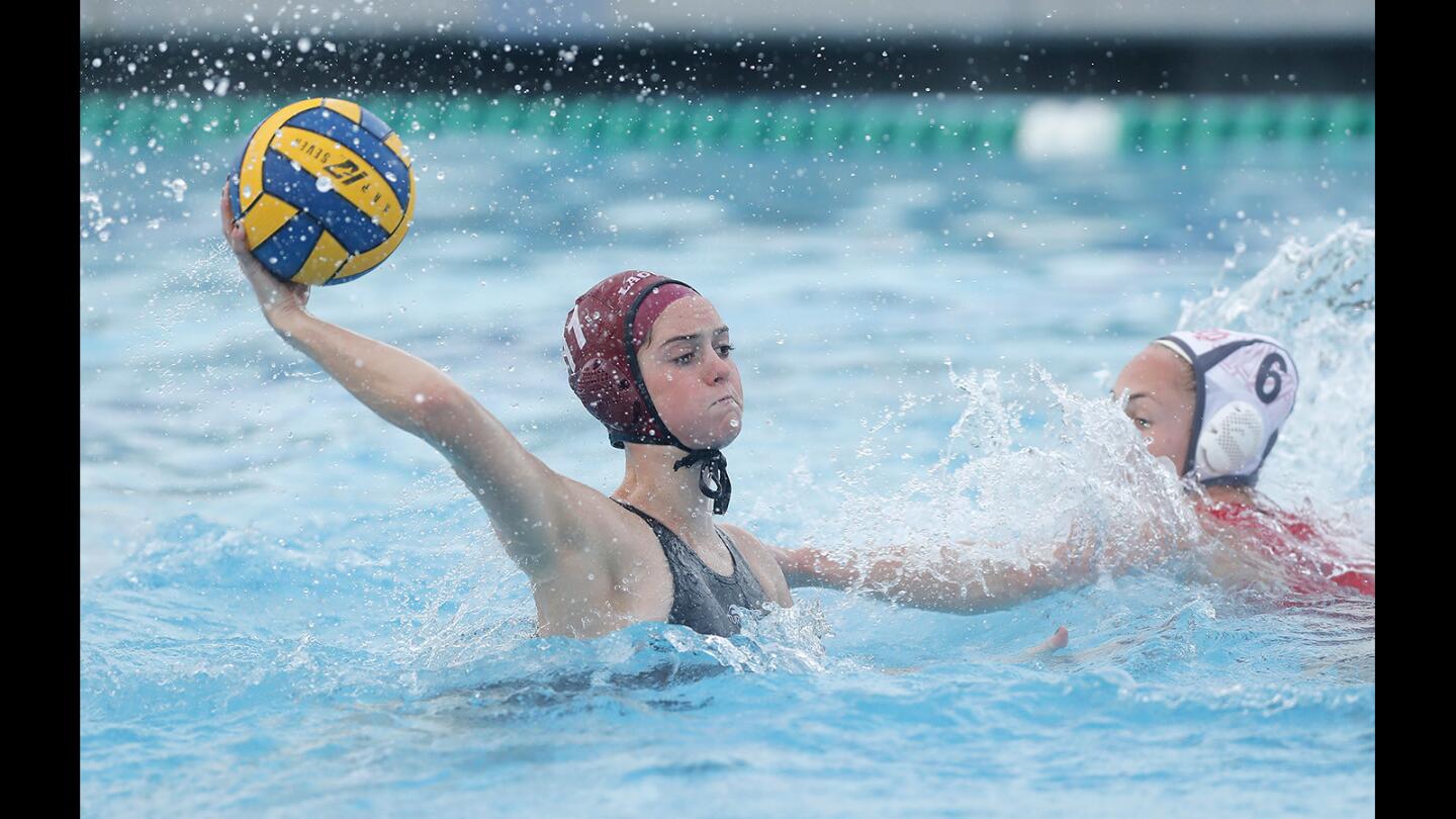 Laguna Beach High's Evan Tingler, left, scores on Mater Dei's Grace Thawley during the first half in the Holiday Cup tournament final on Saturday.