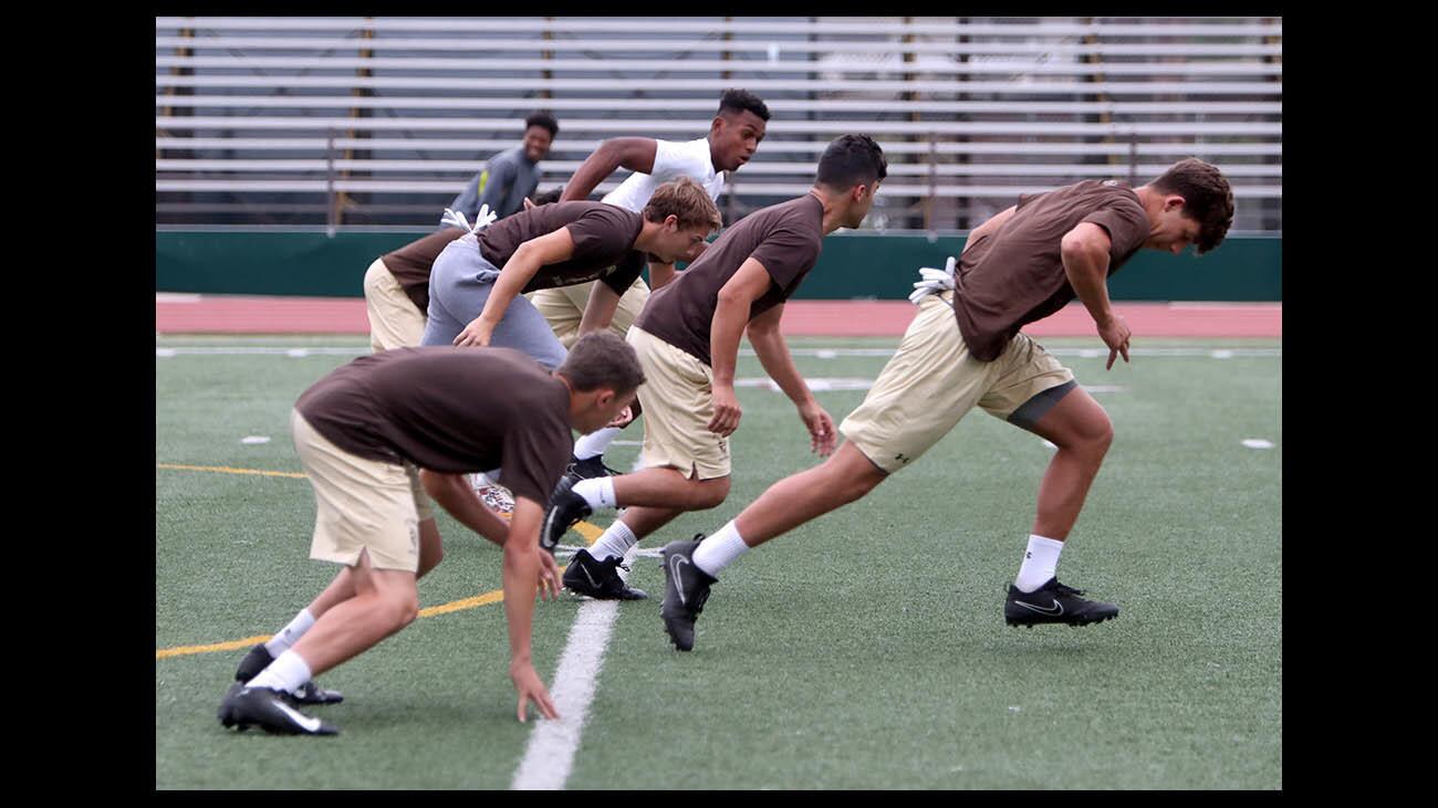 St. Francis High School football team runs through drills during Summer practice at the school in La Canada Flintridge on Friday, June 29, 2018.