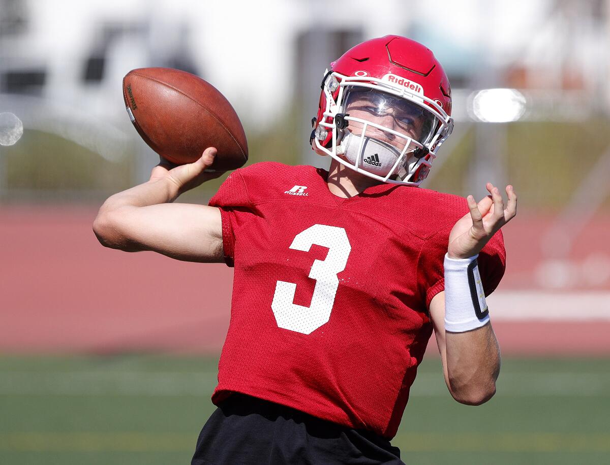 Burroughs' quarterback Nick Garcia throws a pass during a drill at football practice at Burroughs High School in Burbank on Tuesday, August 13, 2019.