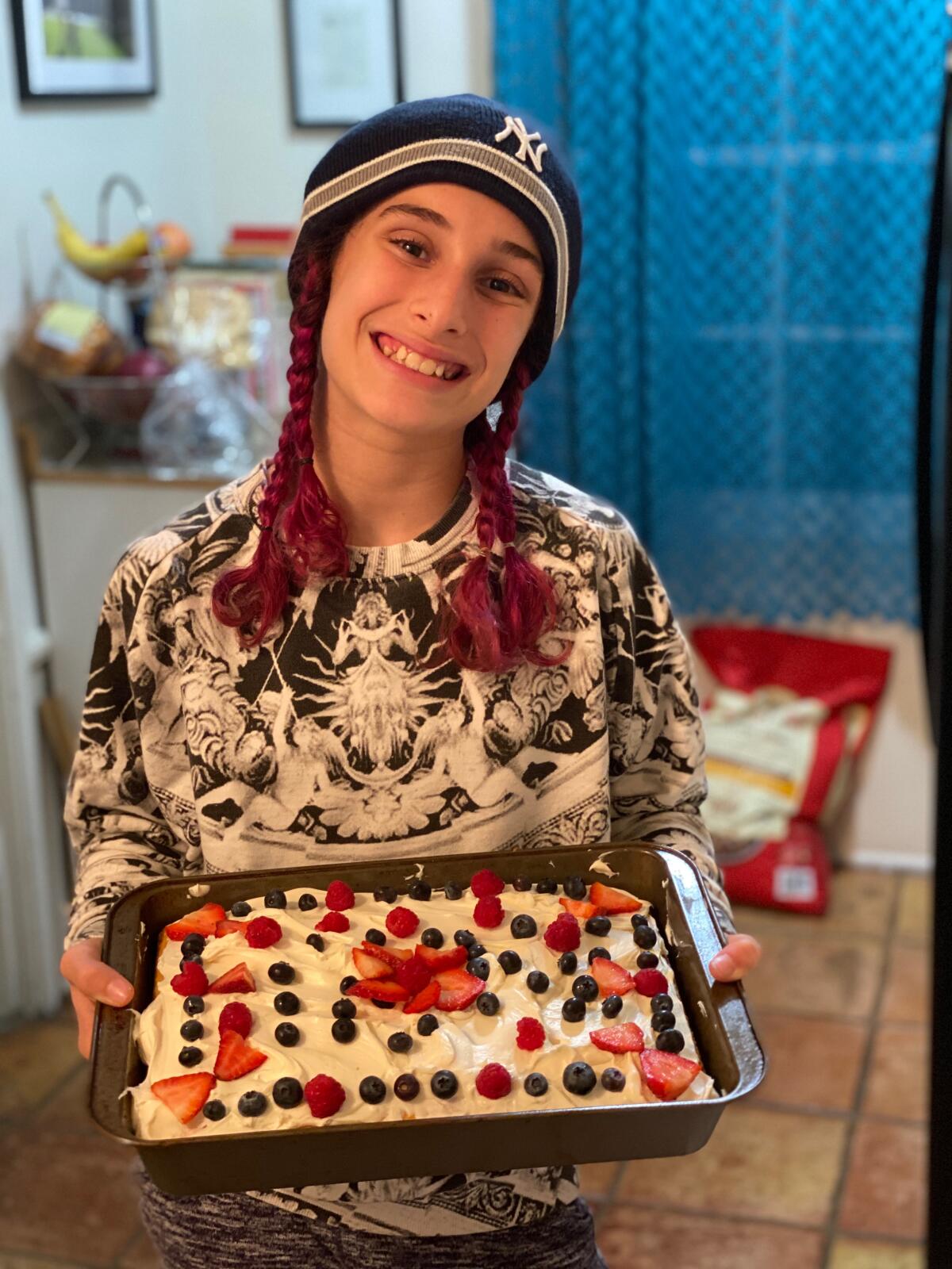 Jaxon Cohen, 11, bakes with her mother during a home-schooling lesson.