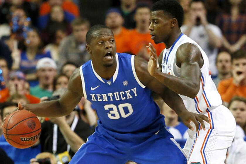 Kentucky forward Julius Randle works in the post against Florida forward Casey Prather during the SEC tournament championship game.