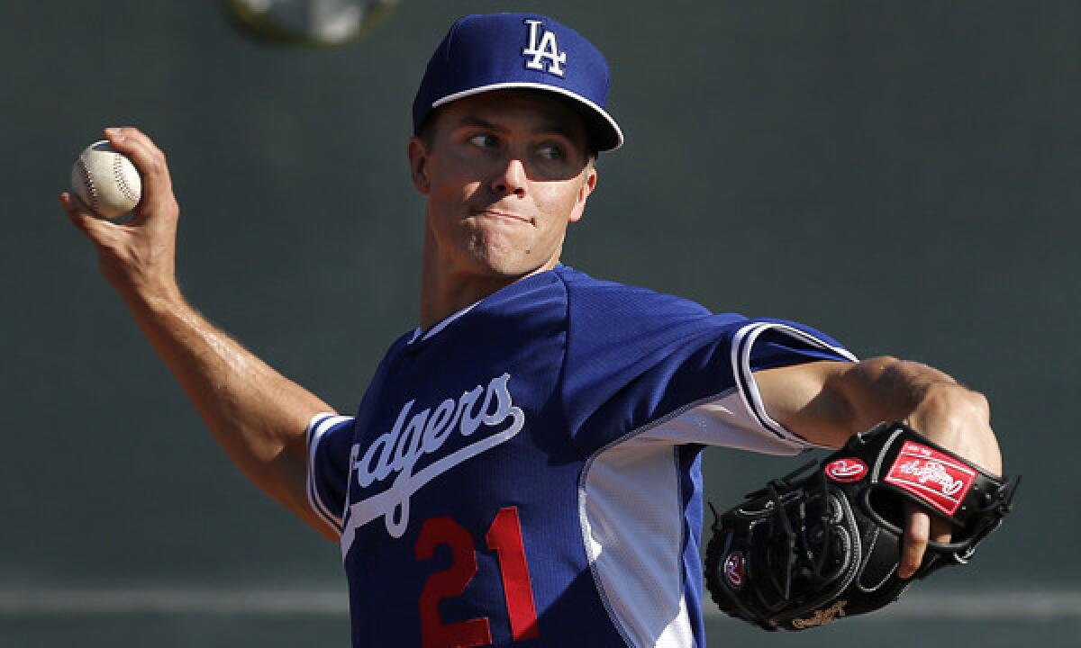 Dodgers starter Zack Greinke throws during a spring training practice session. Greinke struggled at times during the Dodgers' 9-2 Cactus League loss to the Arizona Diamondbacks on Wednesday.