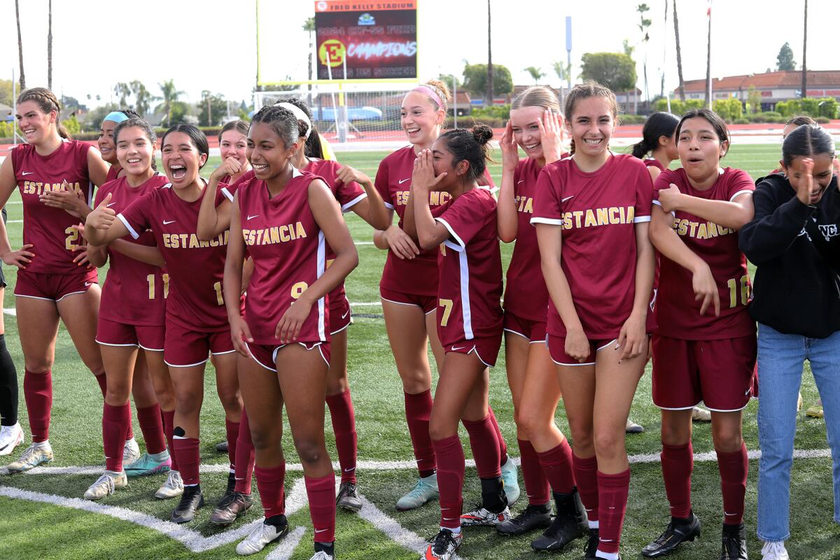The Estancia High girls' soccer team is all smiles as the Eagles celebrate winning against Campbell Hall on Saturday.