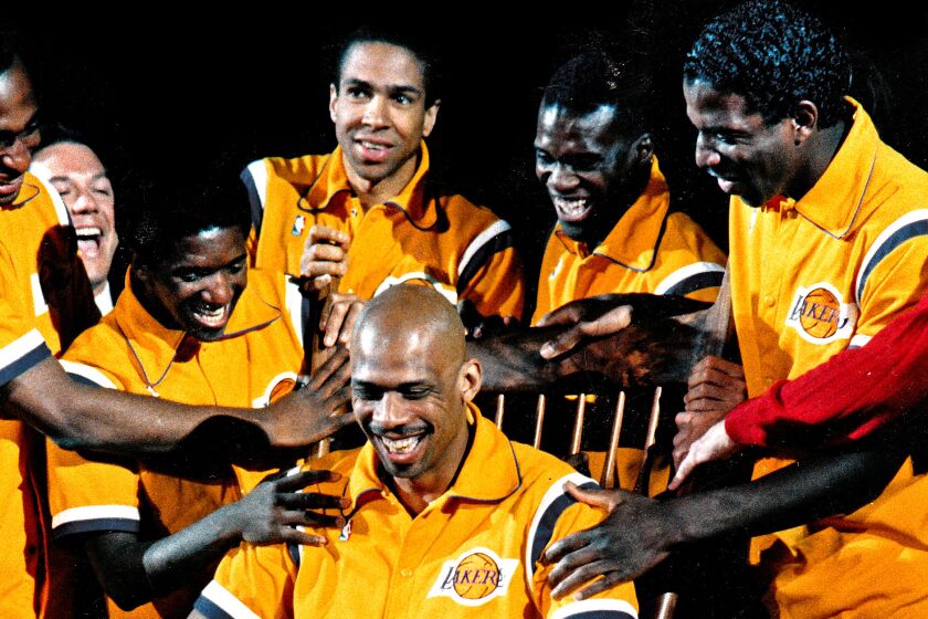 Kareem Abdul–Jabbar is rocked in a rocking chair by his Los Angeles Lakers teammates