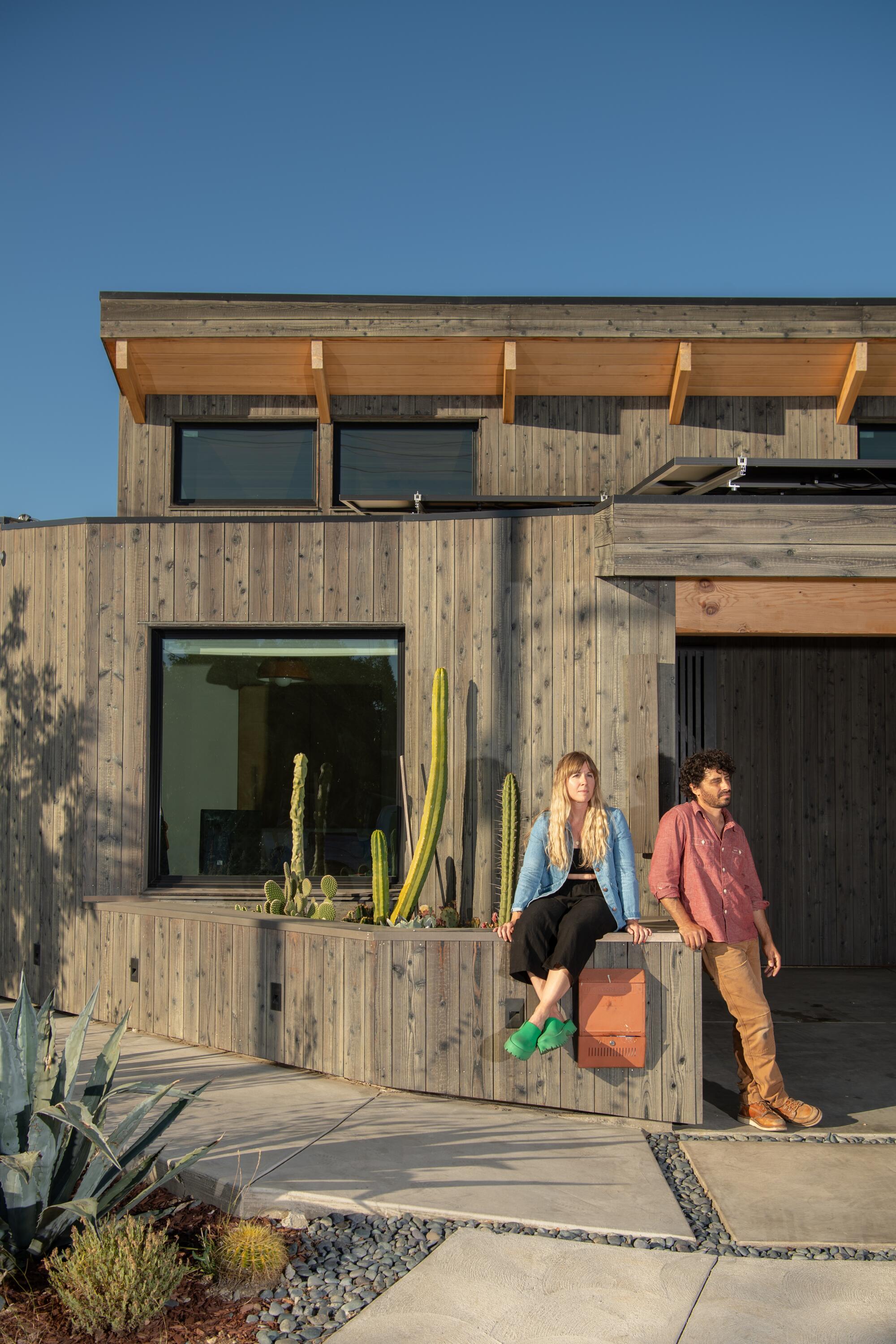 Lindsay and Daniel Sheron stand in front of their home in Mount Washington