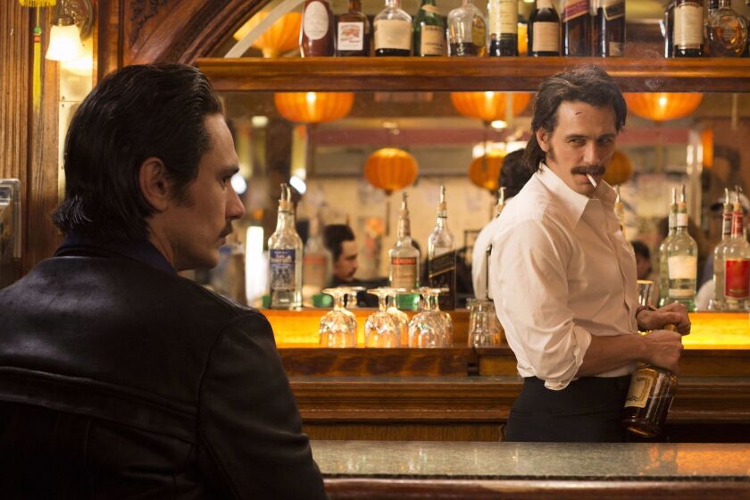 This image released by HBO shows James Franco portraying twins Vincent and Frankie Martino in, "The Deuce," a new HBO series about Times Square in the early 1970s. (HBO via AP)