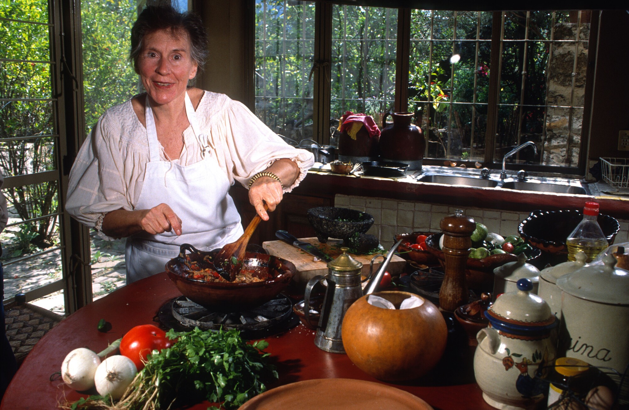 A woman stirs a bowl.
