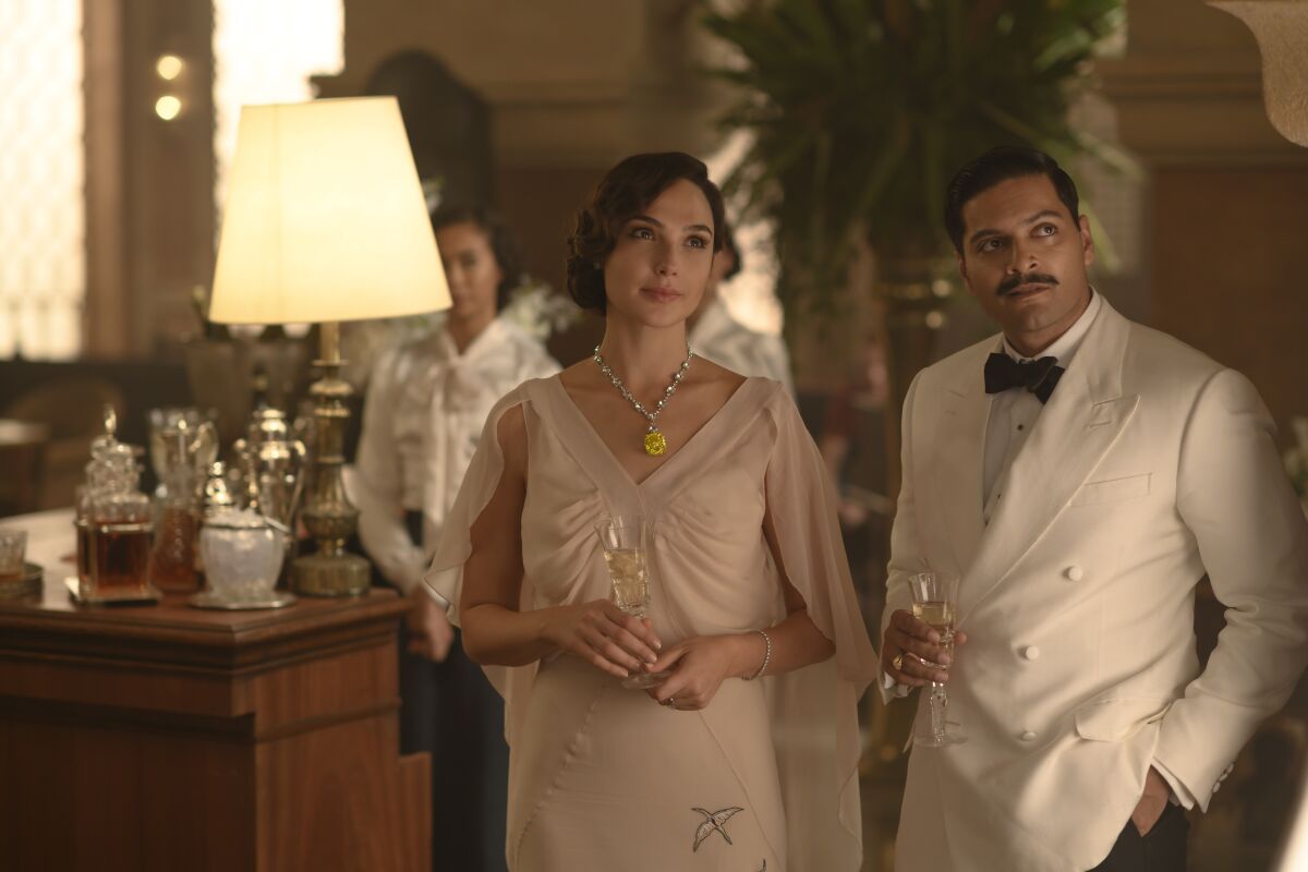 This image released by 20th Century Studios shows Gal Gadot, left, and Ali Fazal in a scene from "Death on the Nile." (Rob Youngson/20th Century Studios via AP)