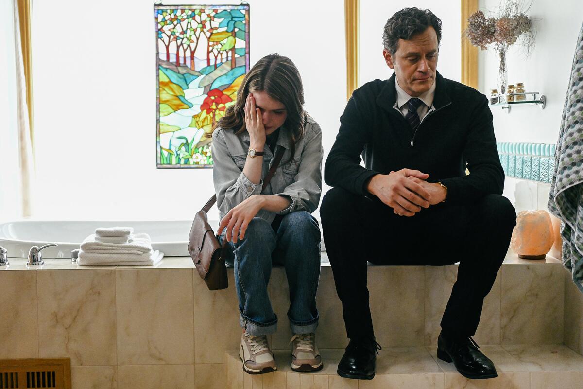 Anwen O’ Driscoll and Tom Everett Scott sit next to each other in a scene from "The Good Father: The Martin MacNeill Story"
