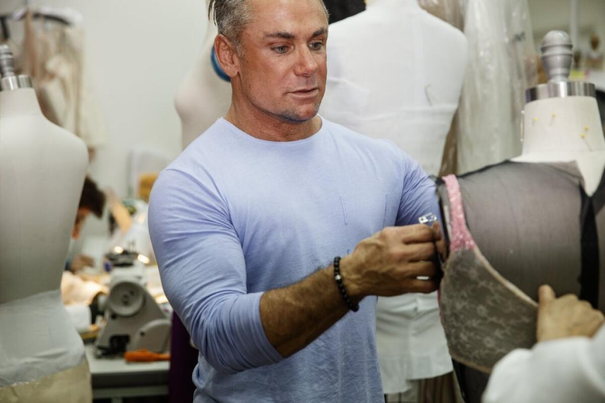Designer Mark Zunino tends to one of his dresses in a workroom of his Beverly Hills showroom. His clients include Julia Roberts, Angelina Jolie, Jennifer Lopez and Beyonce.