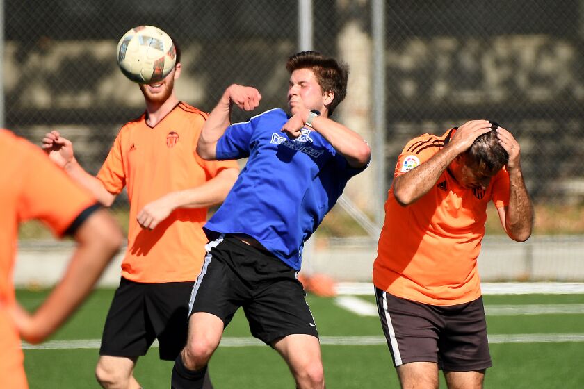 Robert Gray, center, battles for the ball during a Nerd Soccer League game at Cal Tech in Pasadena.