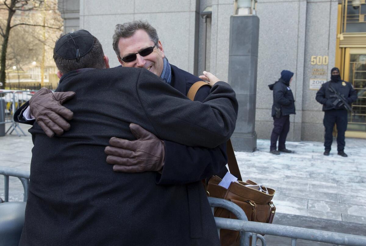 Attorney Kent Yalowitz, right, hugs Mark Weiss of New York outside a federal courthouse in New York on Feb. 23. Yalowitz represents those affected by attacks in Israel in the early 2000s.