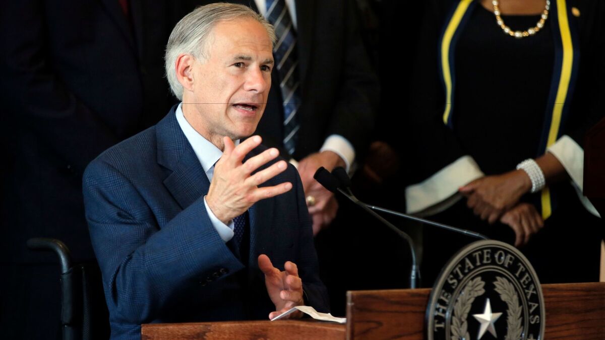 Texas Gov. Greg Abbott responds to questions during a news conference at City Hall in Dallas on July 8.