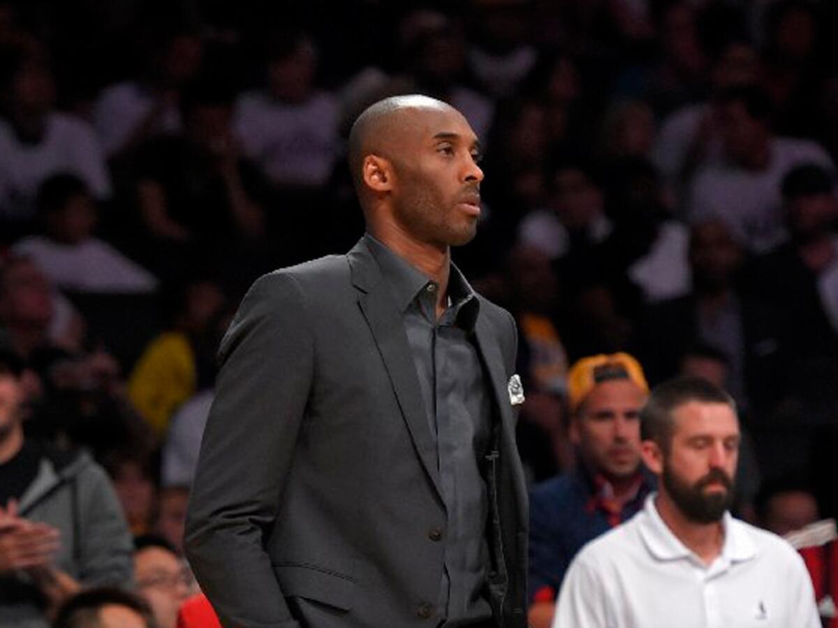 Kobe Bryant stands near the Lakers' bench during a timeout in a game against the Dallas Mavericks on March 8, 2015, at Staples Center.