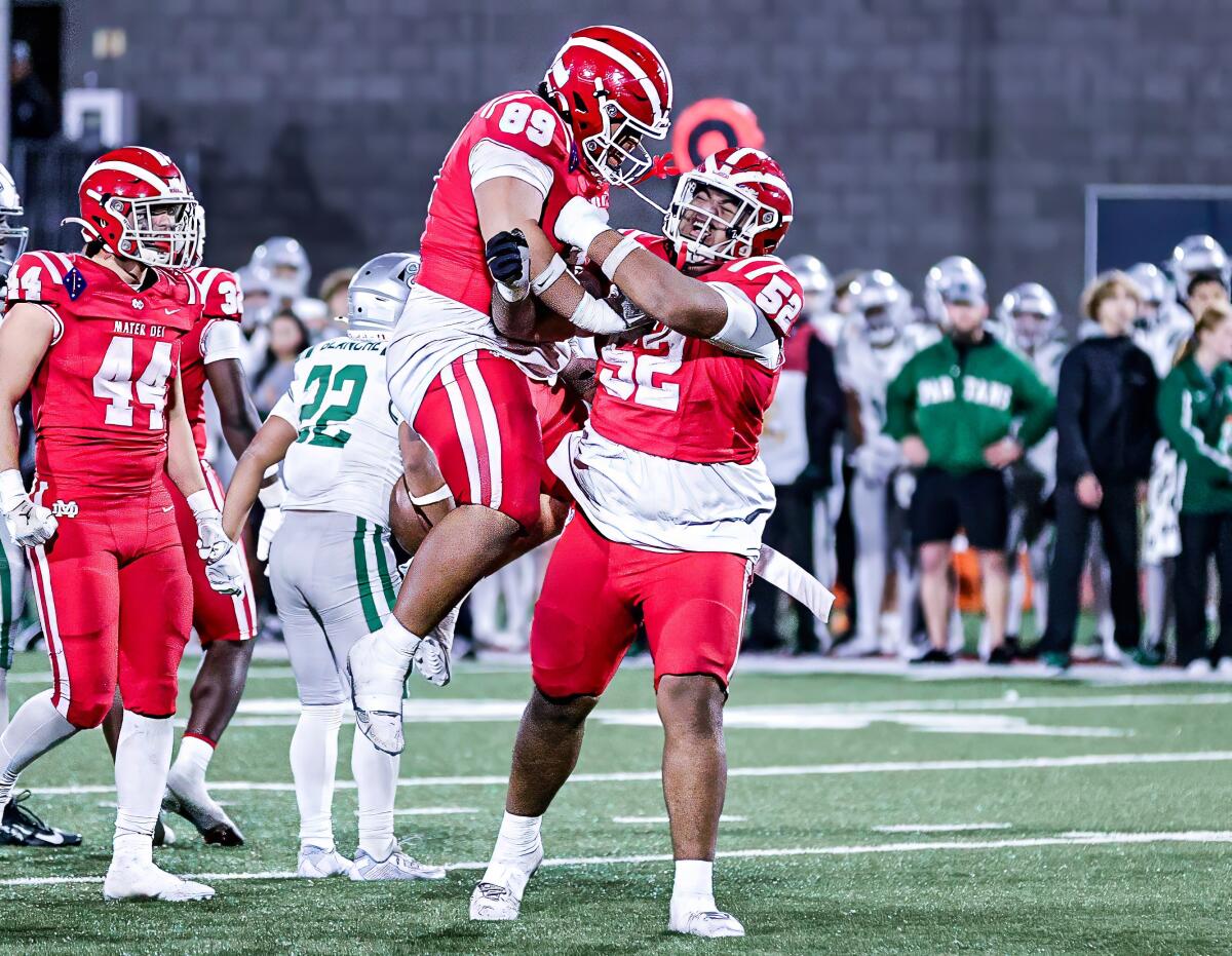 Mater Dei's Tomuhini Topui celebrates with teammate Semi Taulanga after beating De La Salle to complete a 13-0 season.