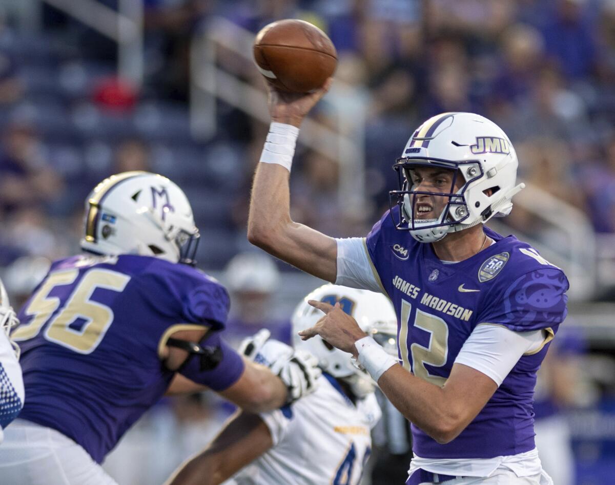 James Madison quarterback Cole Johnson (12) throws a pass during the first half against Morehead State in an NCAA college football game in Harrisonburg, Va., Saturday, Sept. 4, 2021. (Daniel Lin/Daily News-Record via AP)