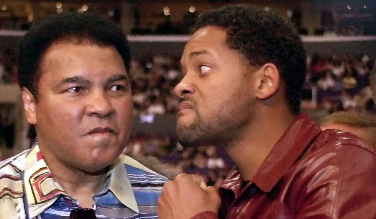 Actor Will Smith, right, jokes with boxing great Muhammad Ali before the start of the Shane Mosley-Oscar De La Hoya fight on June 17, 2000.