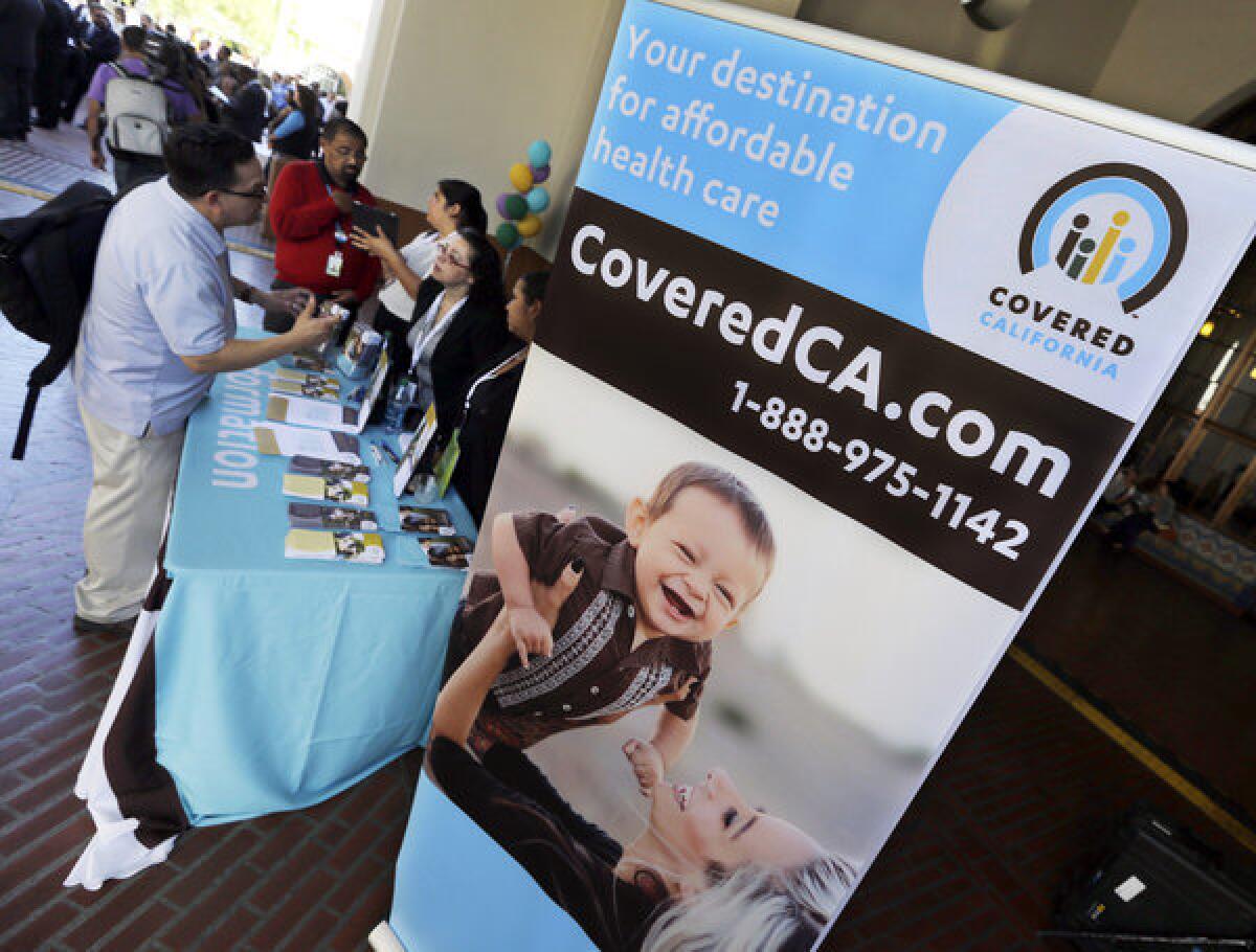 An information table is busy at Union Station in downtown Los Angeles on Oct. 1 as people seek information on health insurance sold through Covered California, the state's new marketplace for coverage.