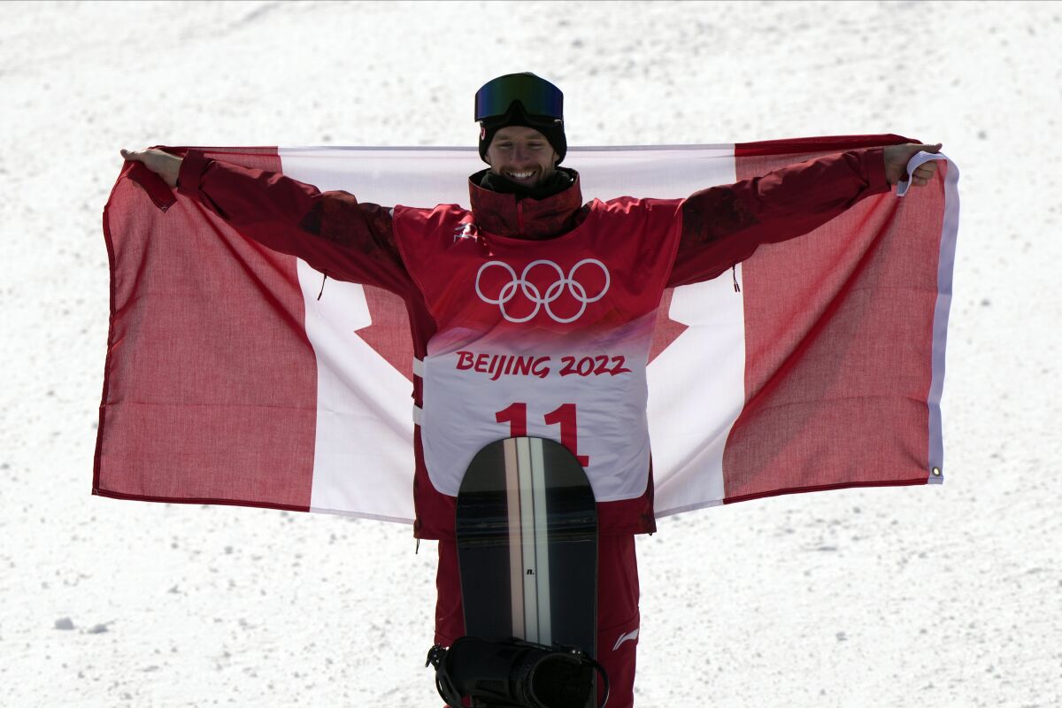 Gold medalist Canada's Max Parrot celebrates during the award ceremony for the men's slopestyle at the 2022 Winter Olympics, Monday, Feb. 7, 2022, in Zhangjiakou, China. (AP Photo/Francisco Seco)