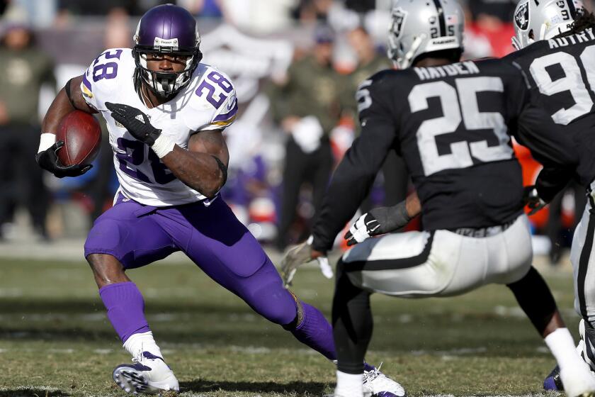 Vikings running back Adrian Peterson finds some room to run against the Raiders in the first half Sunday.