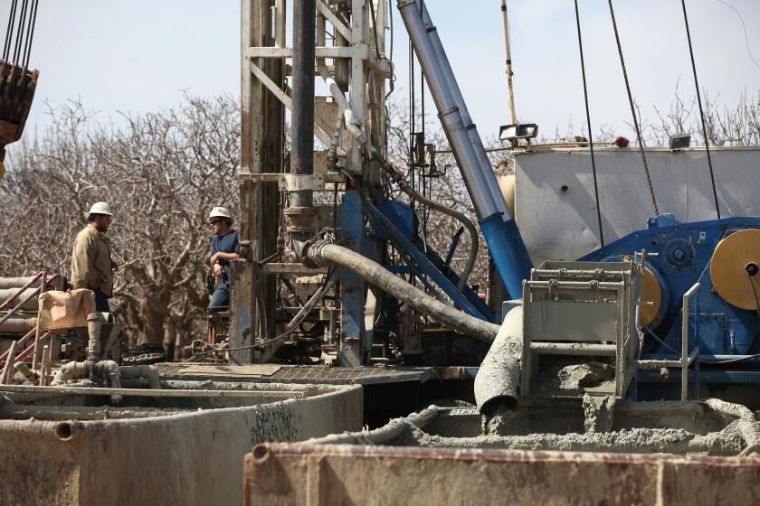 Fluids from the fracking process flow into containment tanks at a oil well near Bakersfield. A new EPA study says that hydraulic fracturing poses risks for drinking water but that the harm is limited. Doubts remain about how comprehensive the study is, however.