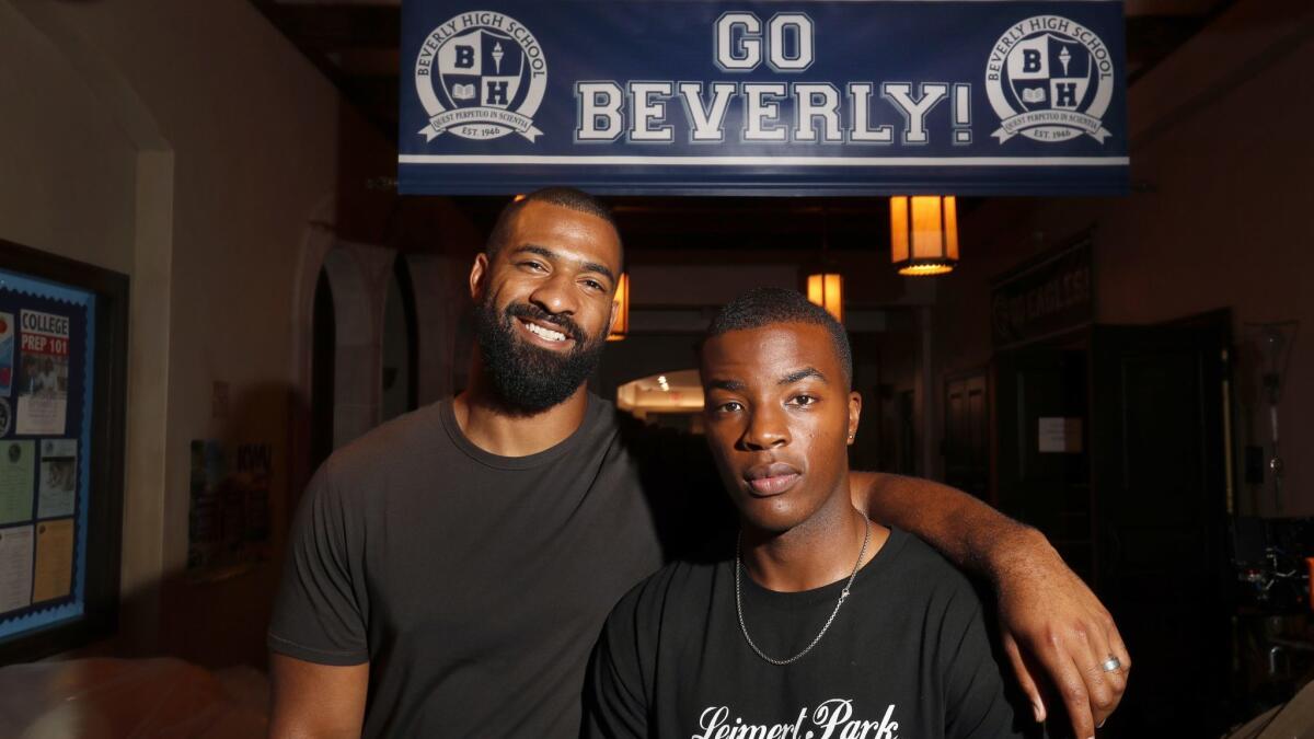 Ex-NFL player Spencer Paysinger, left, bonds with Daniel Ezra, star of the new CW show "All American," which is inspired by the athlete's high school life.