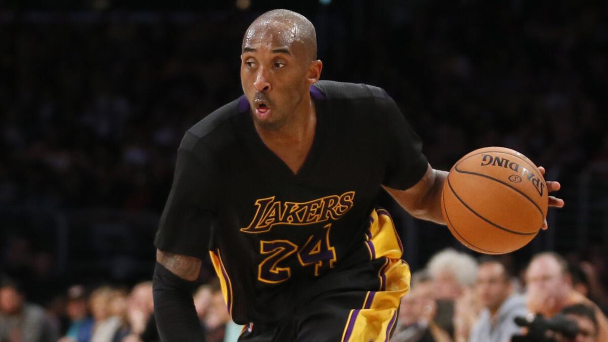 Lakers star Kobe Bryant dribbles the ball against the Minnesota Timberwolves.