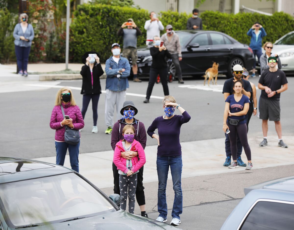 Fans watch as opera singer Victoria Robertson, a soprano, sings from the porch of her North Park home on April 19, 2020. Not everyone was wearing face masks.