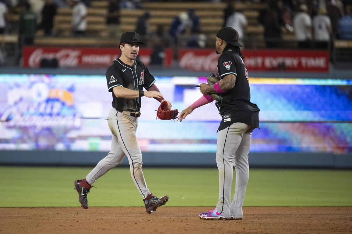 Arizona right fielder Corbin Carroll, left, and Ketel Marte celebrate the team's win over the Dodgers.