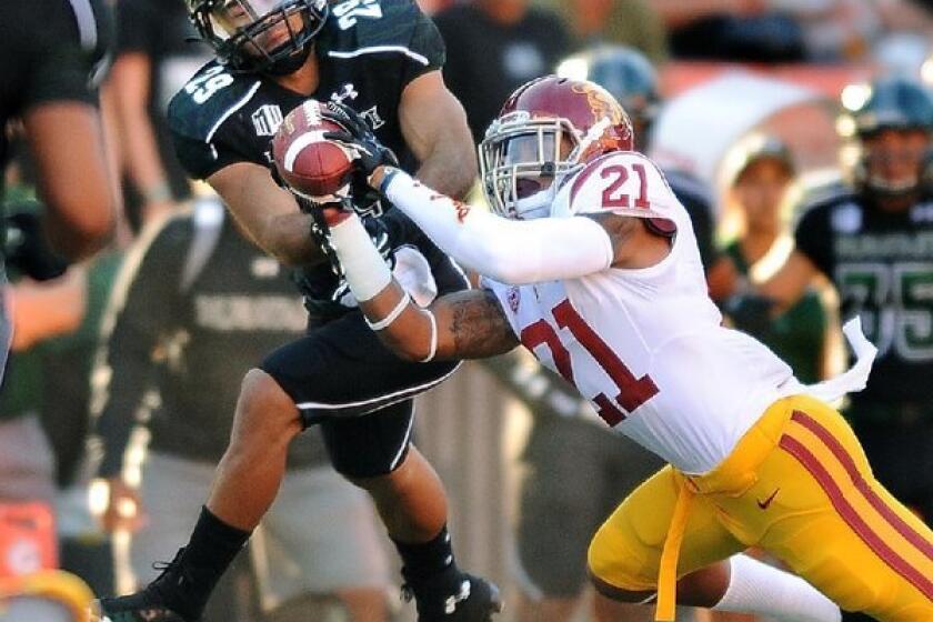 USC's Su'a Cravens intercepts a pass in front of Hawaii receiver Scott Harding in the first quarter.