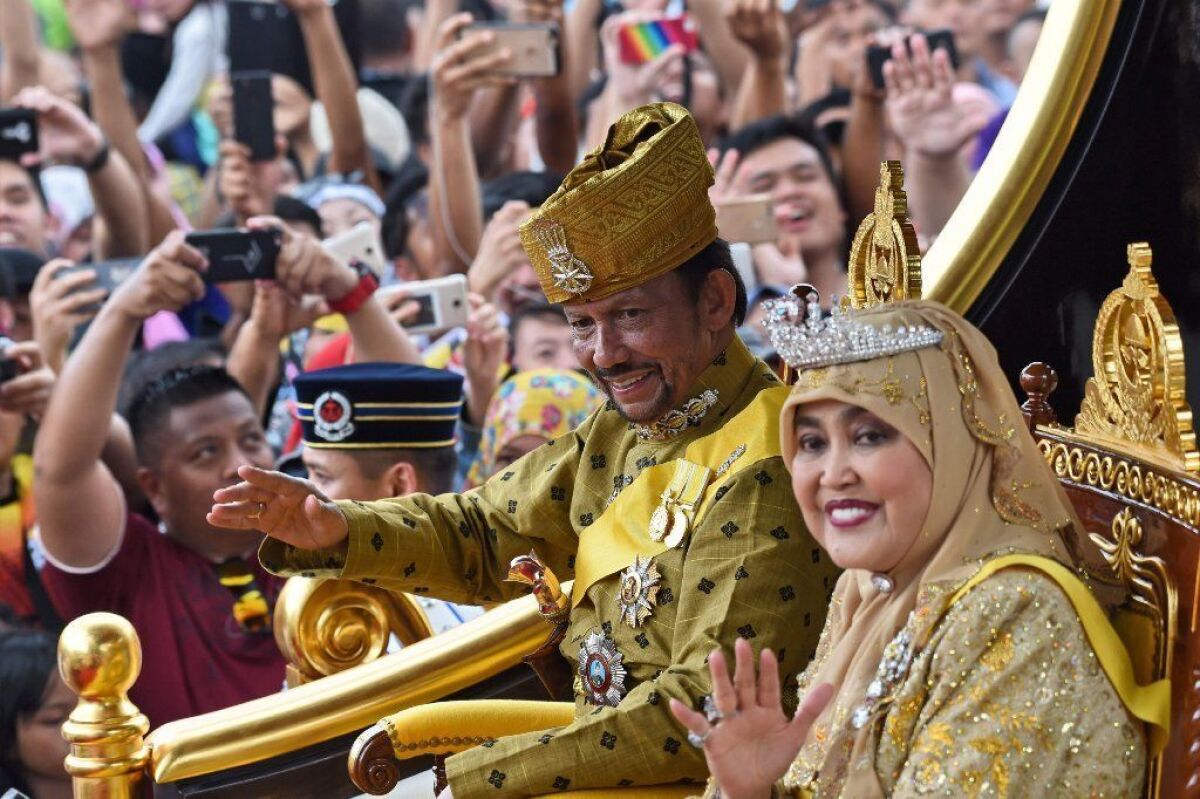 Brunei's Sultan Hassanal Bolkiah and Queen Saleha ride in a royal chariot during a procession in October 2017 to mark 50 years since his accession to the throne.