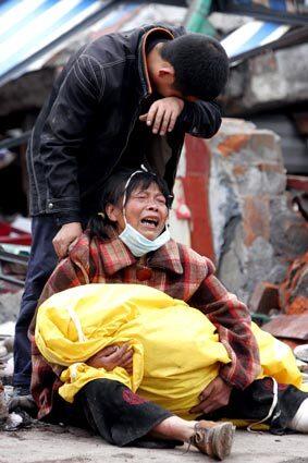 A Chinese woman grieves after she identified her son, who was killed in a collapsed school in Shifang.