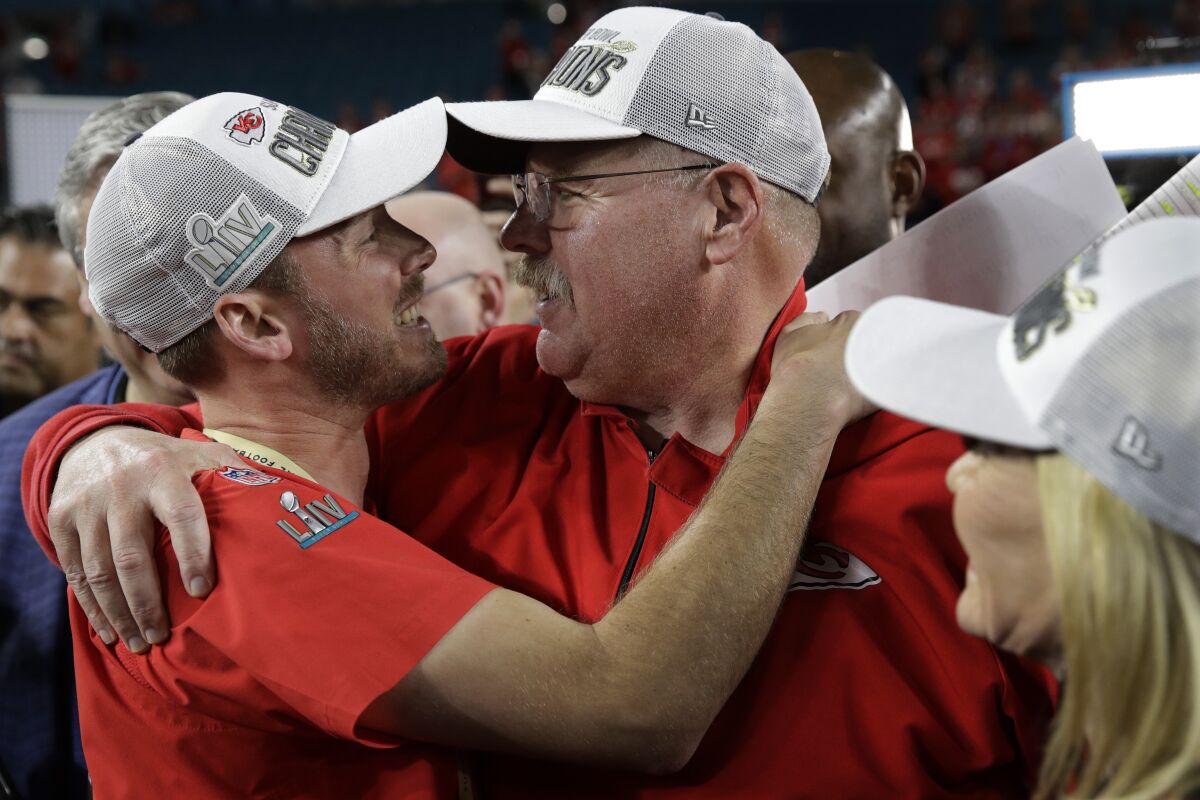 Kansas City Chiefs head coach Andy Reid embraces his son, Britt, after beating the San Francisco 49ers.