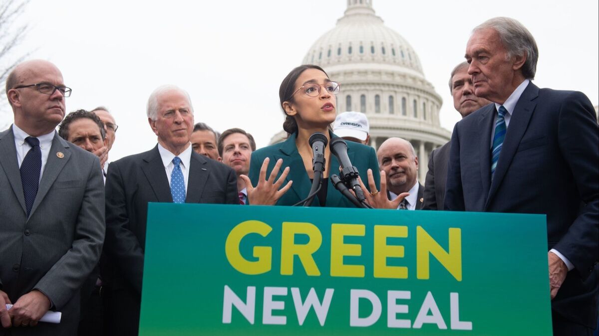 Co-sponsors Rep. Alexandria Ocasio-Cortez (D-N.Y.) and Sen. Ed Markey (D-Mass.), right, unveil legislation proposing a Green New Deal that would dramatically shift the U.S. away from fossil fuels and toward renewable energy.