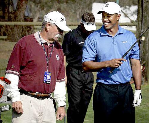 HOME ON THE RANGE: Tiger Woods shares a laugh with his former caddy, Fluff Cowan, on the driving range during practice for the Nissan Open at Riviera Country Club.